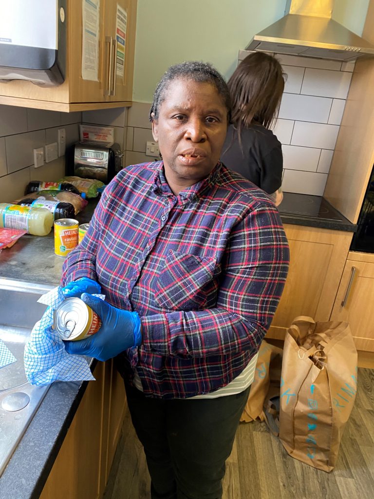 Person we support wipes down tinned food