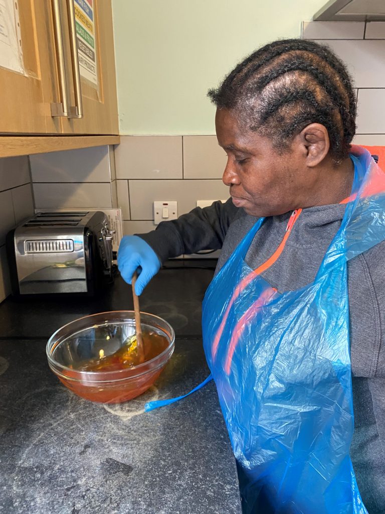 Person we support baking in the kitchen