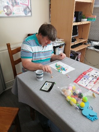 Andrew sat at the table painting a picture