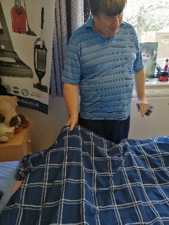 Andrew making his bed