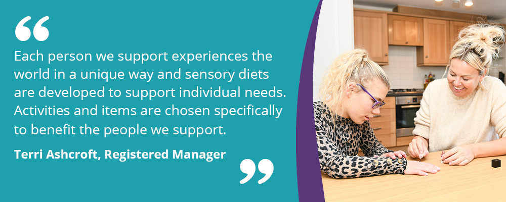 A picture of a person we support with their support worker. They are painting their nails. Accompanying text reads, "Each person we support experiences the world in a unique way and sensory diets are developed to support individual needs. Activities and items are chosen specifically to benefit the people we support. Terri Ashcroft, Registered Manager." 