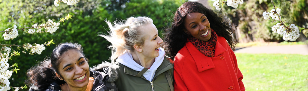 A group of women walking through a park.